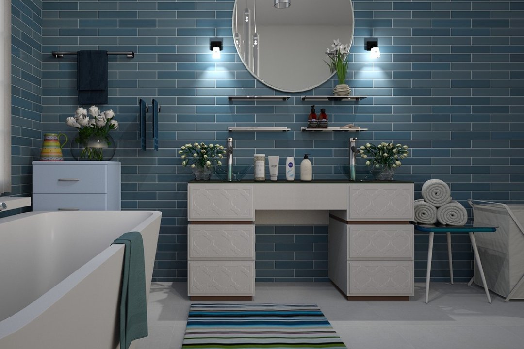 Stylish bathroom with modern tiled walls, vanity unit, and decor accents